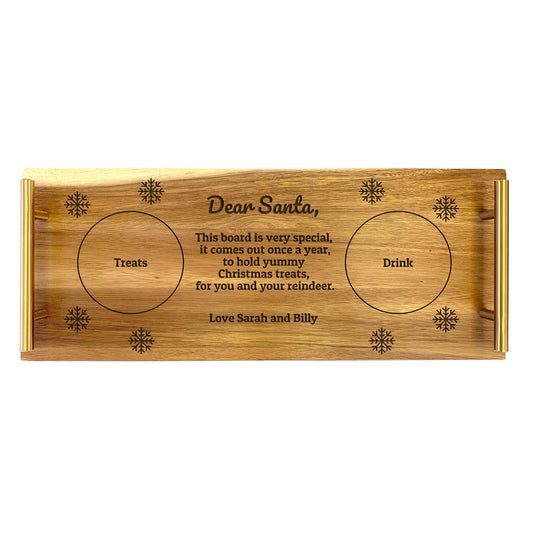 A large acacia wood serving tray with 'Dear Santa, this board is very special' text and Christmas-themed engravings, including areas for treats, drinks, and signatures.