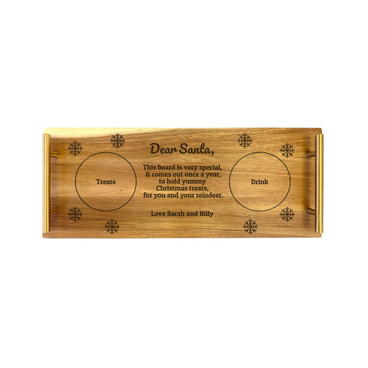 A small serving tray with 'Dear Santa' text and Christmas-themed engravings, made from Acacia wood.