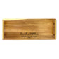 A large rectangular wooden serving tray with laser-engaved text 'Sarah's Kitchen - SERVING LOVE SINCE 2020'.
