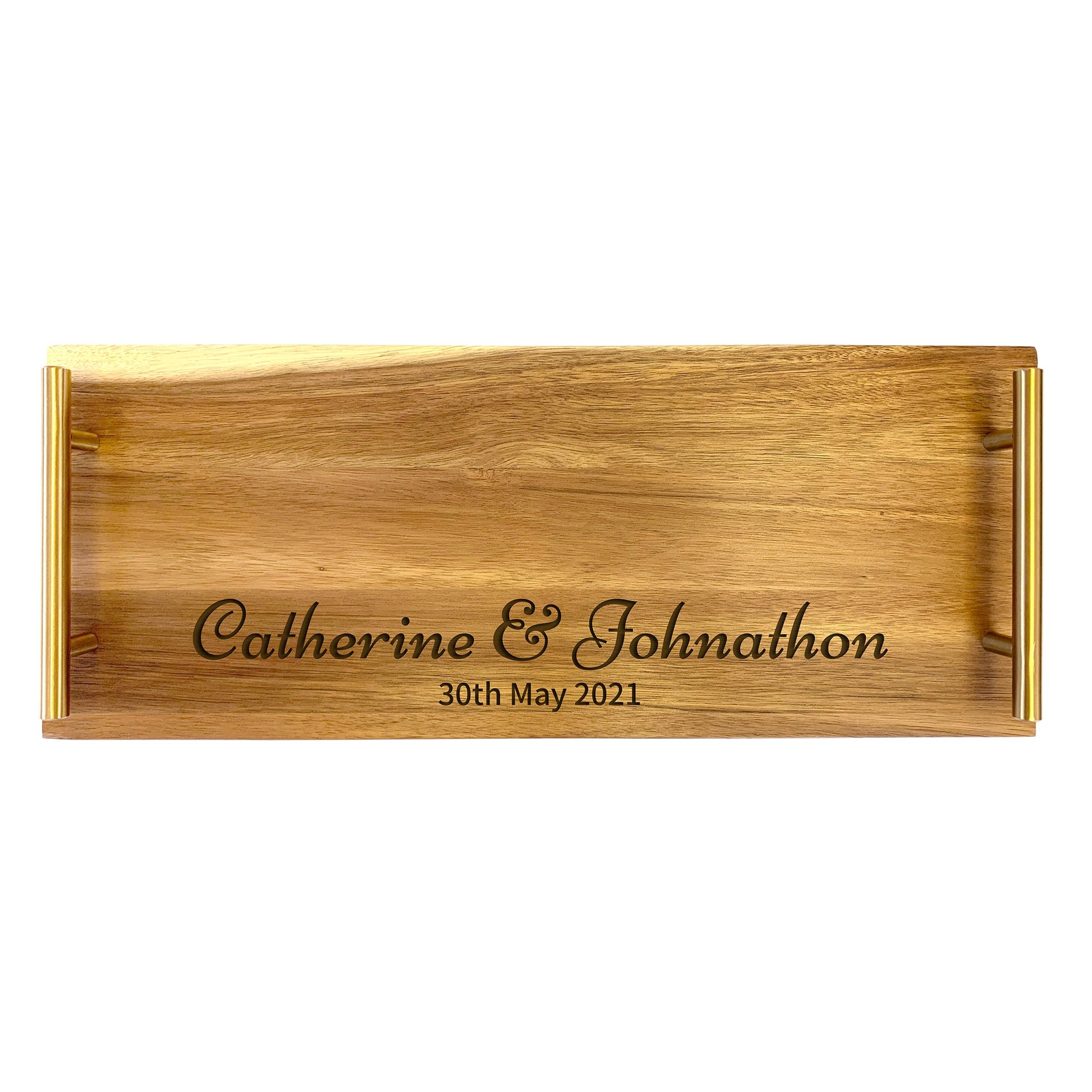 A large serving tray made from acacia wood, with a laser-engraved design of a couple's names and a date on the tray's surface.