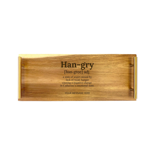 A small rectangular wooden serving tray with the text 'HANGRY' engraved on it, alongside a humorous message that reads 'In case of good news, hang a bell; in case of bad news, hang a cat.'.
