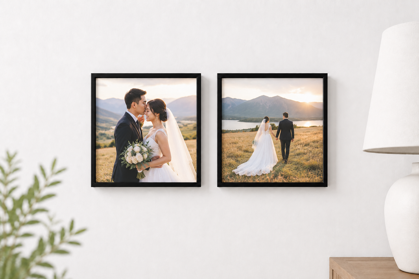 Two framed custom wedding photograph tiles hanging side-by-side on a white wall, with a white table lamp on the right and green leaves on the left.