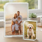 Two glass photo blocks personalised with family and pet images on a desk.