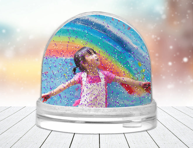 A personalised Photo Snow Globe with a picture of a girl and glitter raining down